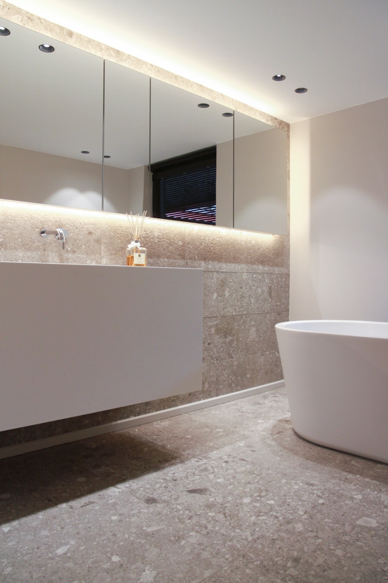 white bathtub near white bathtub
